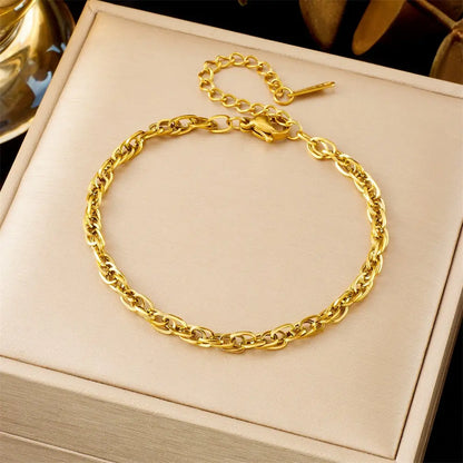 Gold chain bracelet on a beige jewelry box 599 Hole Ring Chain