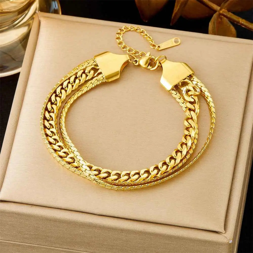Gold-toned double-layered titanium steel chain bracelet with sleek interlocking design from luxury fashion bracelet collection
