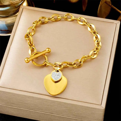 Gold-toned titanium steel oval link fashion bracelet with toggle clasp and heart pendant from trend den collection
