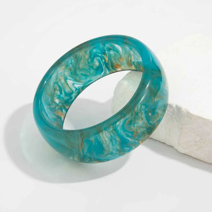 Marbled translucent resin statement bangle in turquoise with swirling white and gold patterns from trend den Blue