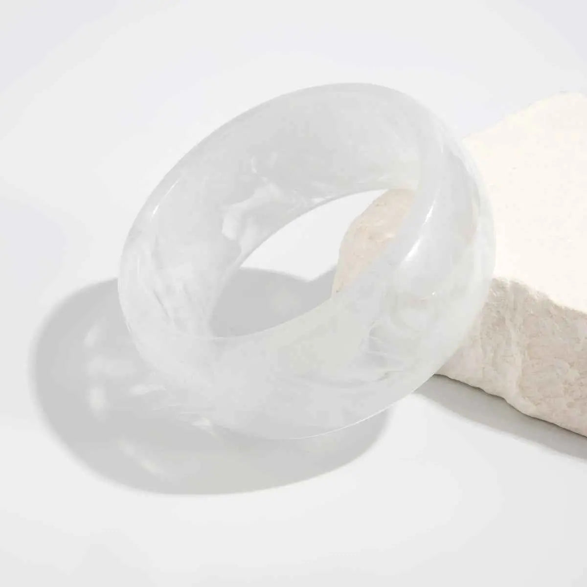 Marbled translucent resin statement bangle with a smooth polished surface and subtle natural veining in translucent white Milky White