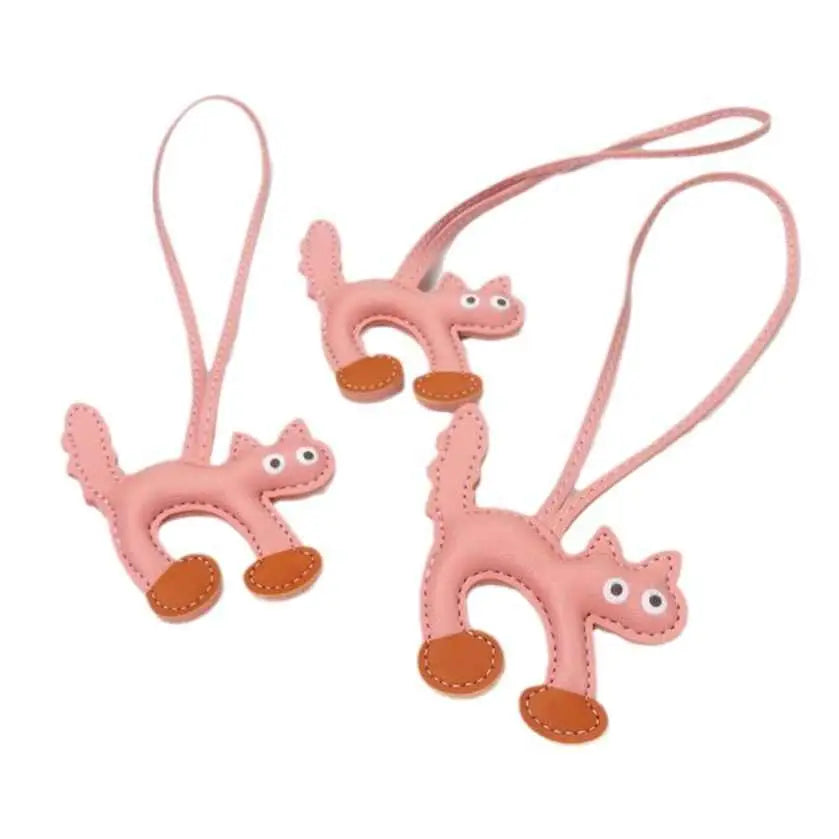 Pink leather mini cat bag charm with brown paw pads and stitched details from trend den collection Pink