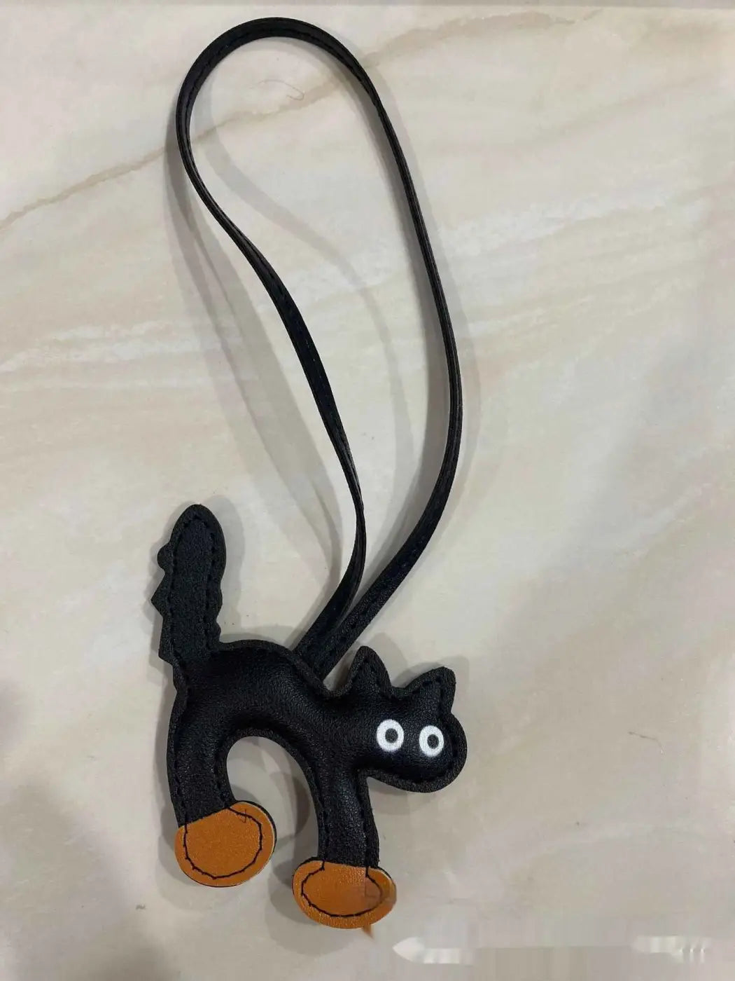 Black leather mini cat bag charm with orange paw pads and white eyes for trend den cat bag and handbag pendant Black