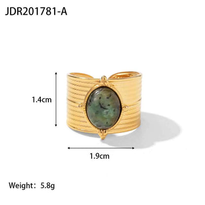 Gold-toned cuff bracelet with textured ribbed band and oval green natural stone in an ornate adjustable zircon bezel JDR201781 A