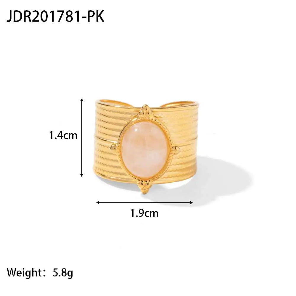 Gold-toned cuff bracelet with ribbed band and oval pink rose quartz stone in an ornate bezel natural stone trend den JDR201781 PK