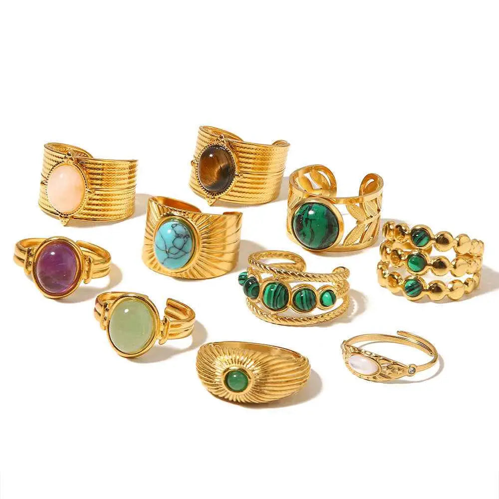 A collection of gold-toned adjustable zircon rings with natural stone gemstones in green blue purple and brown shades