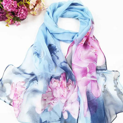 A delicate light blue silk georgette sunscreen scarf with oil painting floral pink peony blossoms and watercolor brushstrokes A