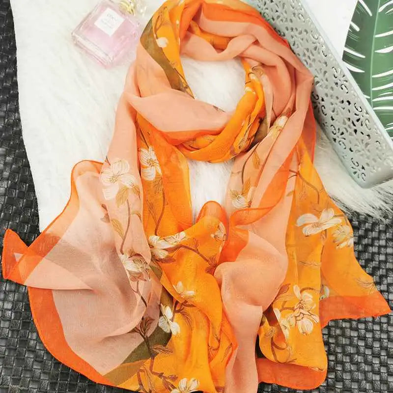 Oil painting floral georgette sunscreen scarf in flowing orange and peach with white blossoms and green stems made of sheer fabric O