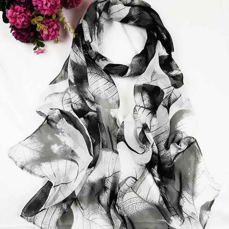 A flowing black and white oil painting floral georgette scarf with delicate semi-transparent fabric for sunscreen use A