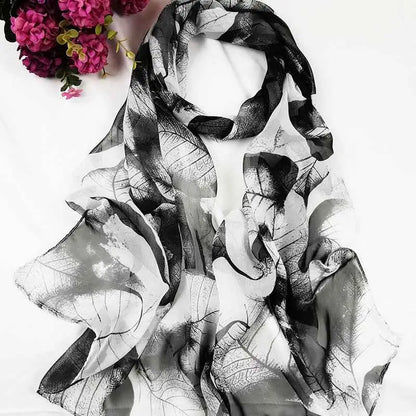 A flowing black and white oil painting floral georgette scarf with delicate semi-transparent fabric for sunscreen use A
