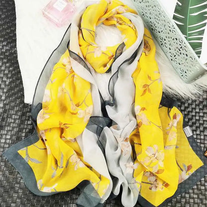 A vibrant yellow and gray oil painting floral georgette sunscreen scarf made of sheer lightweight fabric A