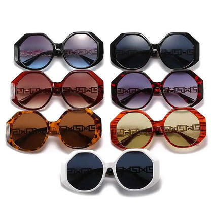 Black oversized polygonal sunglasses with geometric patterned frame and gradient blue lenses for trend den style