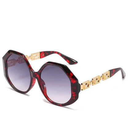 Oversized polygonal sunglasses in red and black tortoiseshell with gold-tone geometric detailing on the arms In Stock