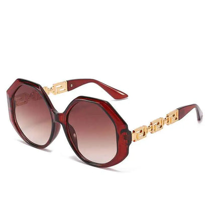 Oversized polygonal designer sunglasses in burgundy with gold-toned geometric arms and gradient brown lenses from trend den In Stock