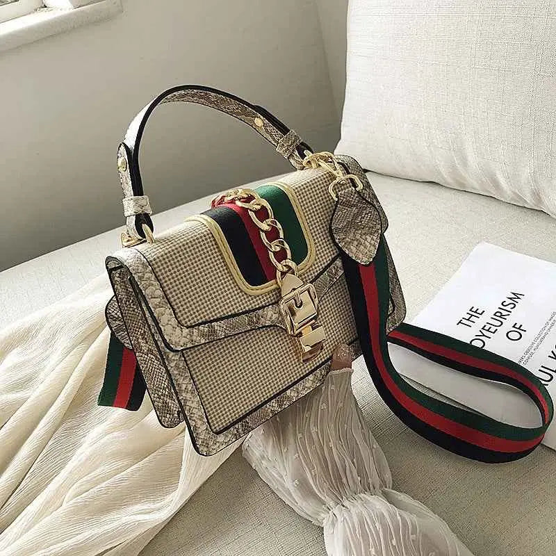 Beige and green gucci plaid satchel with snake trim, snakeskin texture, gold hardware, and red and green webbing strap