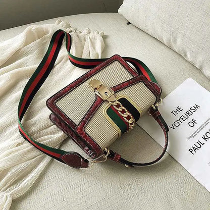 Beige and burgundy plaid satchel with snake trim, woven crossbody bag, and green red black webbing strap from trend den