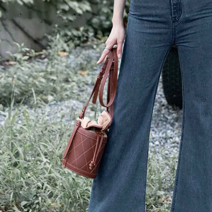 Brown leather bucket bag with quilted base diamond stitching and drawstring closure from trend den collection