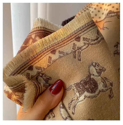 Beige retro carriage jacquard scarf with brown horse pattern and fringed edges held by hand with red nails