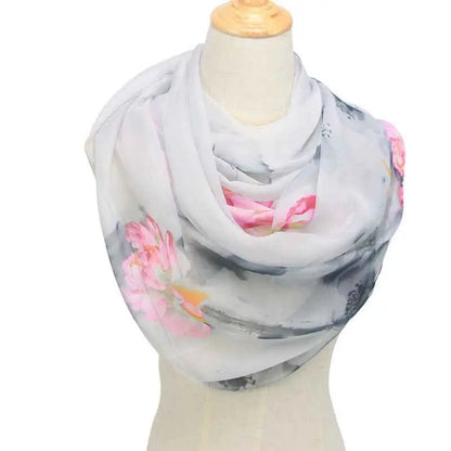 A delicate light gray retro ethnic floral georgette sunscreen scarf with soft pink and black patterns draped on a mannequin Light Grey