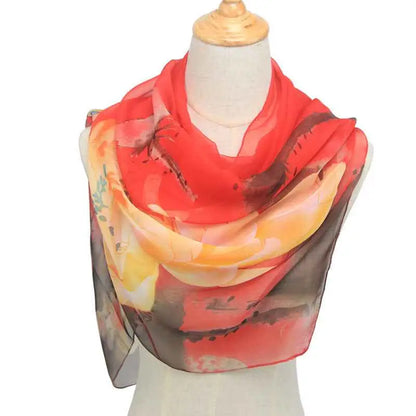 A vibrant red and orange retro ethnic floral georgette sunscreen scarf draped elegantly over a mannequin Red