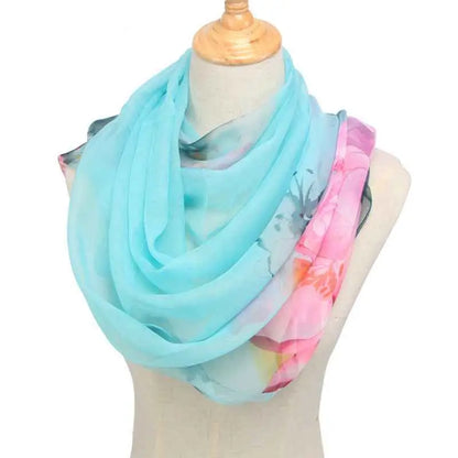 A soft sheer georgette sunsceen scarf in light blue and pink with retro ethnic floral patterns Water blue