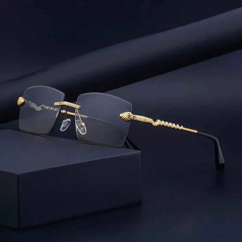 Gold-toned snake-embossed rimless rectangular gradient sunglasses with dark gray lenses and black temple tips