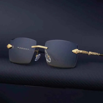 Rimless rectangular gradient sunglasses with gold-toned snake-head frame and dark gray lenses from trend den