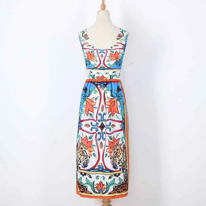 Sleeveless retro print cake dress by Dolce & Gabbana with bold floral and leopard print in orange blue red and green