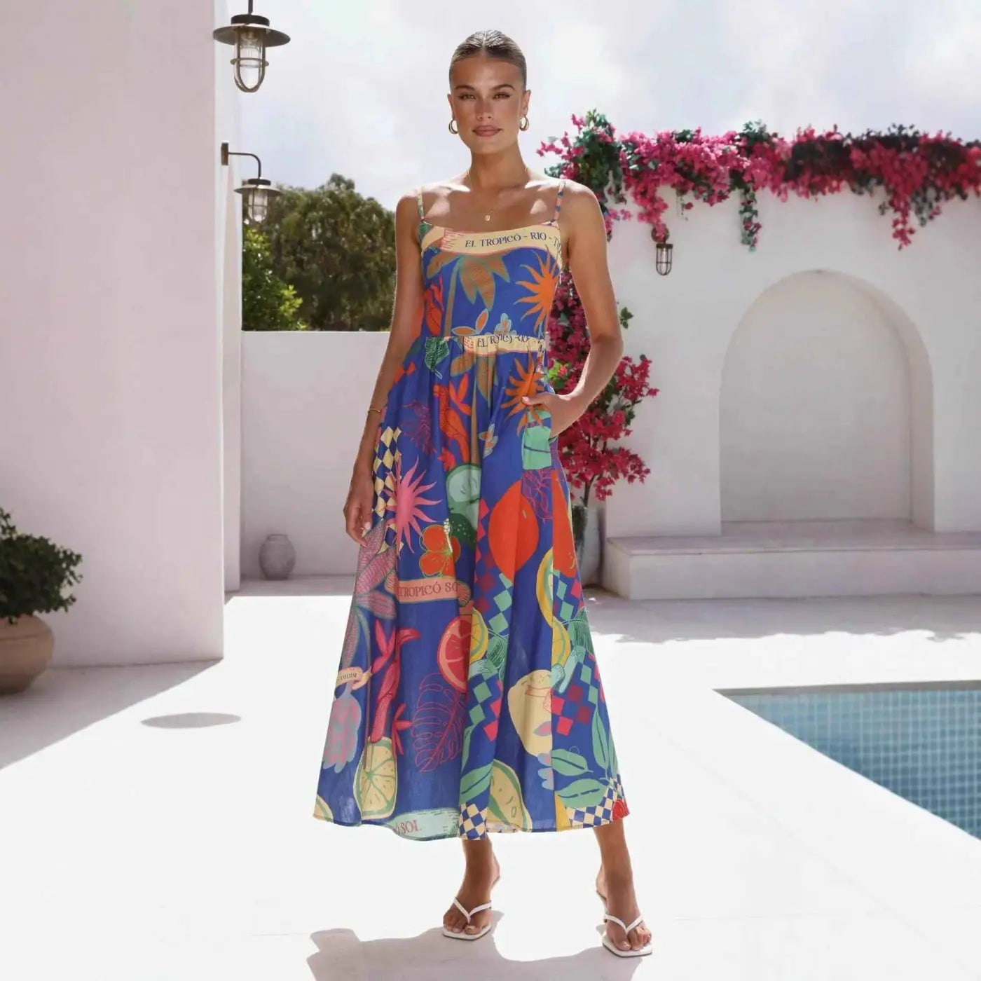 A vibrant blue south african linen print slip dress with colorful tropical lemons flowers and geometric patterns Color