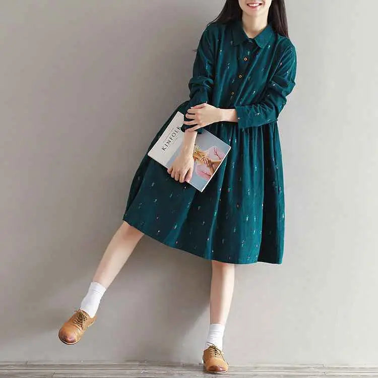 Long sleeve printed corduroy dress in teal velvet with small metallic dots featuring a subtle south african pattern
