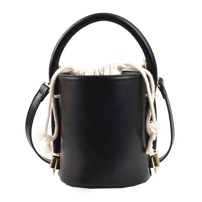 Black leather cylinder bucket bag with top handle, adjustable shoulder strap, and cream drawstring closure trend den Black