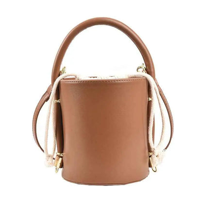 Structured cylinder bucket bag in tan leather with curved top handle and cream rope straps from trend den Brown