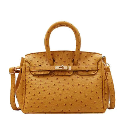 Structured ostrich-pattern handbag in tan with embossed texture, gold-tone clasp, matching handles, and durable polyester