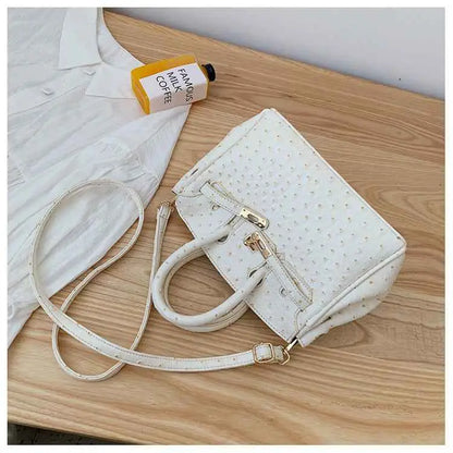 White ostrich-pattern handbag with gold-tone hardware and detachable shoulder strap made of durable polyester from trend den White