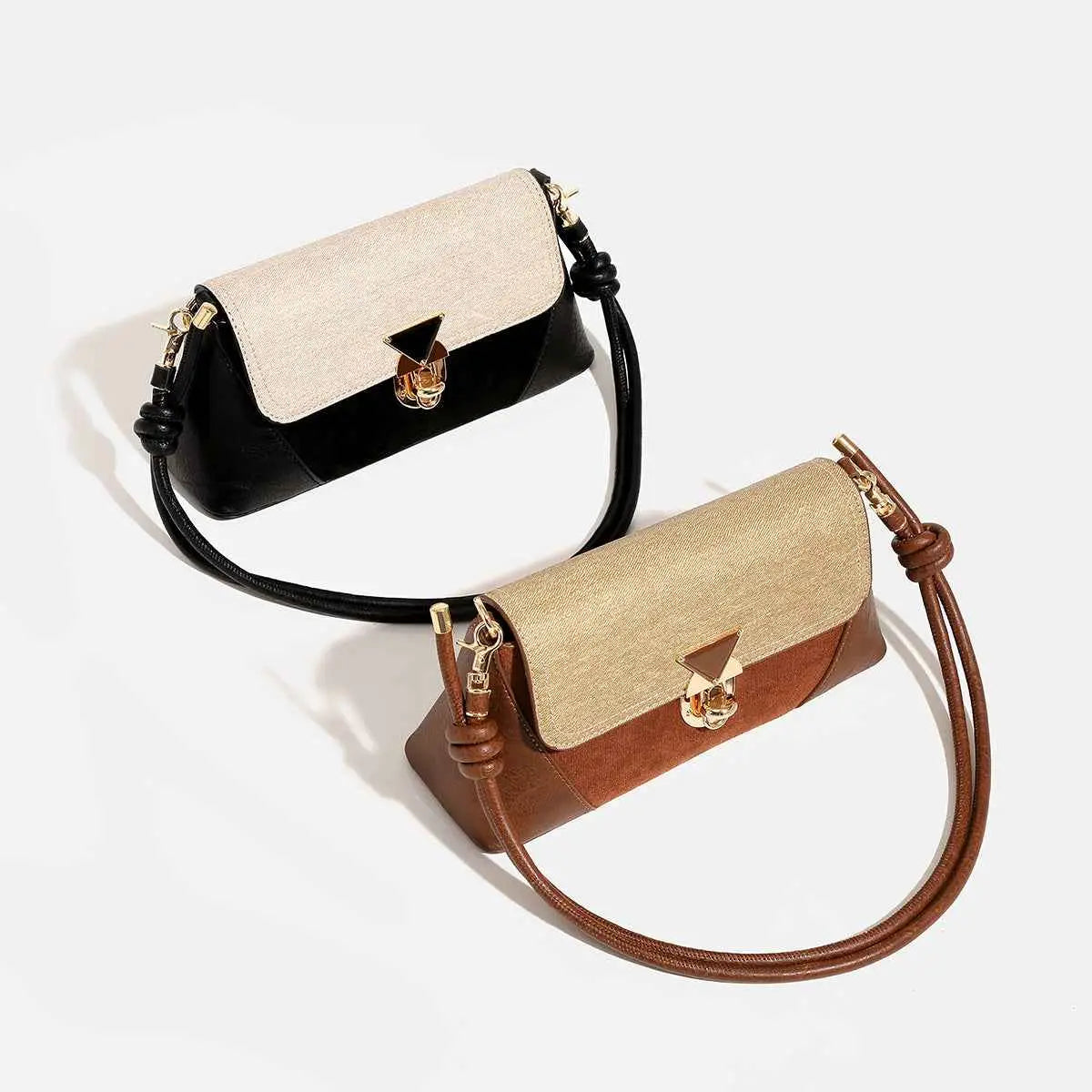 Two-tone baguette underarm bags in black beige with gold clasp and brown tan with matching hardware from trend den