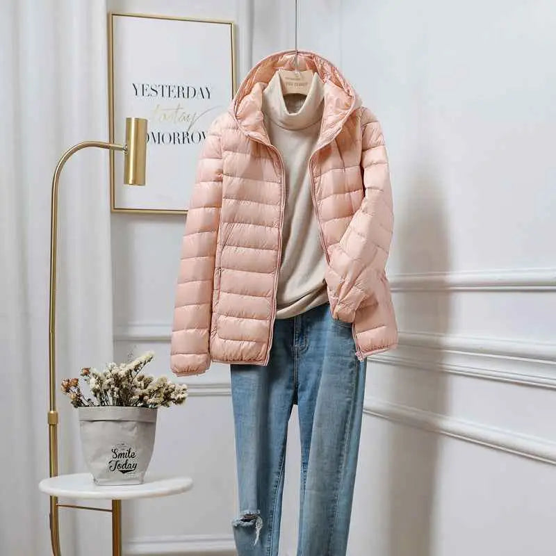A soft pink quilted ultra-lightweight women’s hooded down jacket featuring white duck fill by trend den south african brand Cherry Pink