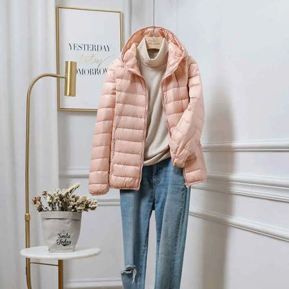 A soft pink quilted ultra-lightweight women’s hooded down jacket featuring white duck fill by trend den south african brand Cherry Pink