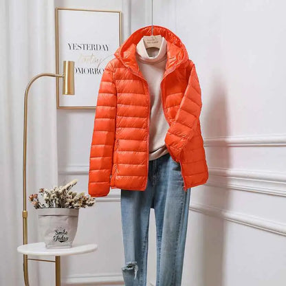 Bright orange quilted ultra-lightweight women’s hooded down jacket made with white duck down by trend den south african brand Orange