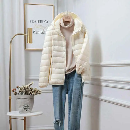 Cream-colored quilted ultra-lightweight women’s hooded down jacket made with white duck filling from trend den White