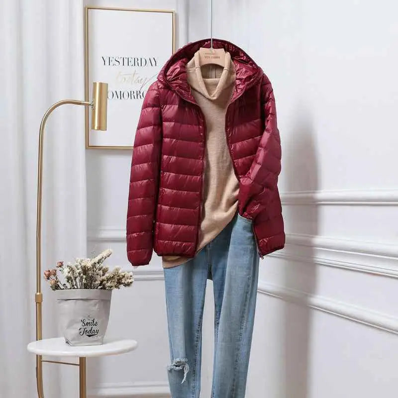 Ultra-lightweight women’s quilted maroon hooded puffer jacket with high collar made from white duck down by trend den Wine Red