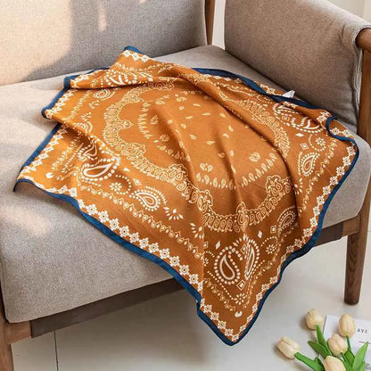 Vintage print emulation silk square scarf in warm orange with intricate white paisley patterns and navy trim from trend den