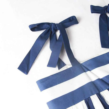 Navy blue satin ribbon bow on a white and navy striped vintage sleeveless printed midi dress