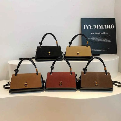 Black and tan leather vintage structured buckle tote and crossbody bag with gold-tone hardware from trend den