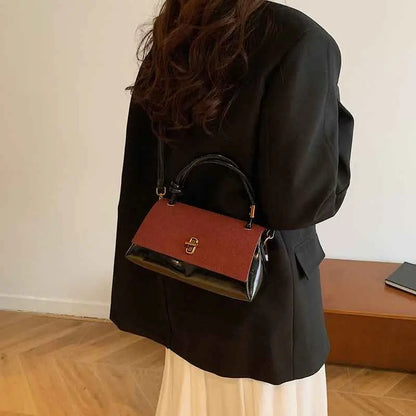 Vintage structured buckle tote and crossbody bag with two-tone reddish brown matte flap and glossy black sides with gold hardware