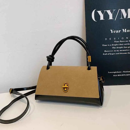 Tan and black vintage structured buckle tote and crossbody bag with gold hardware and a rectangular shape by trend den