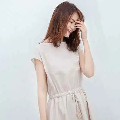 A soft beige sleeveless waist-in loose cotton linen swing dress with a relaxed fit inspired by south african style Apricot