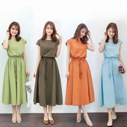 Four women model south african waist-in loose cotton linen swing dresses in light green olive orange and light blue colors