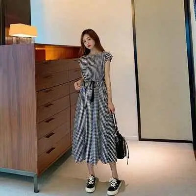 Black and white checkered cotton linen swing dress with fitted waistband and a-line silhouette from south african brand Lattice