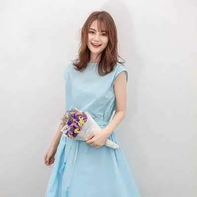 A woman wearing a light blue waist-in loose cotton linen swing dress with a fitted bodice and flowing skirt south african style Sky Blue