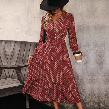 A woman wears a long sleeve printed autumn dress in burgundy with a subtle white floral pattern and button-down front Wine Red
